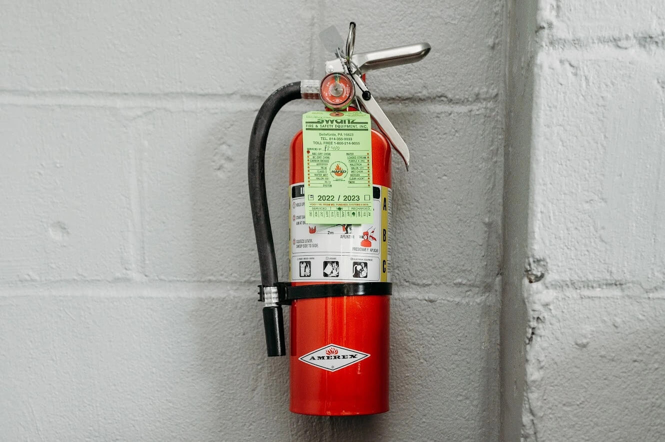 An abc fire extinguisher hanging on a wall